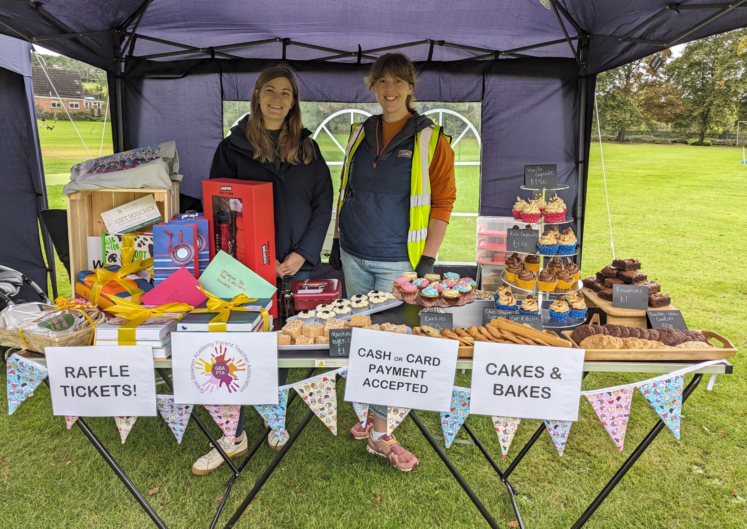 PTA volunteers manning a raffle and cake stall